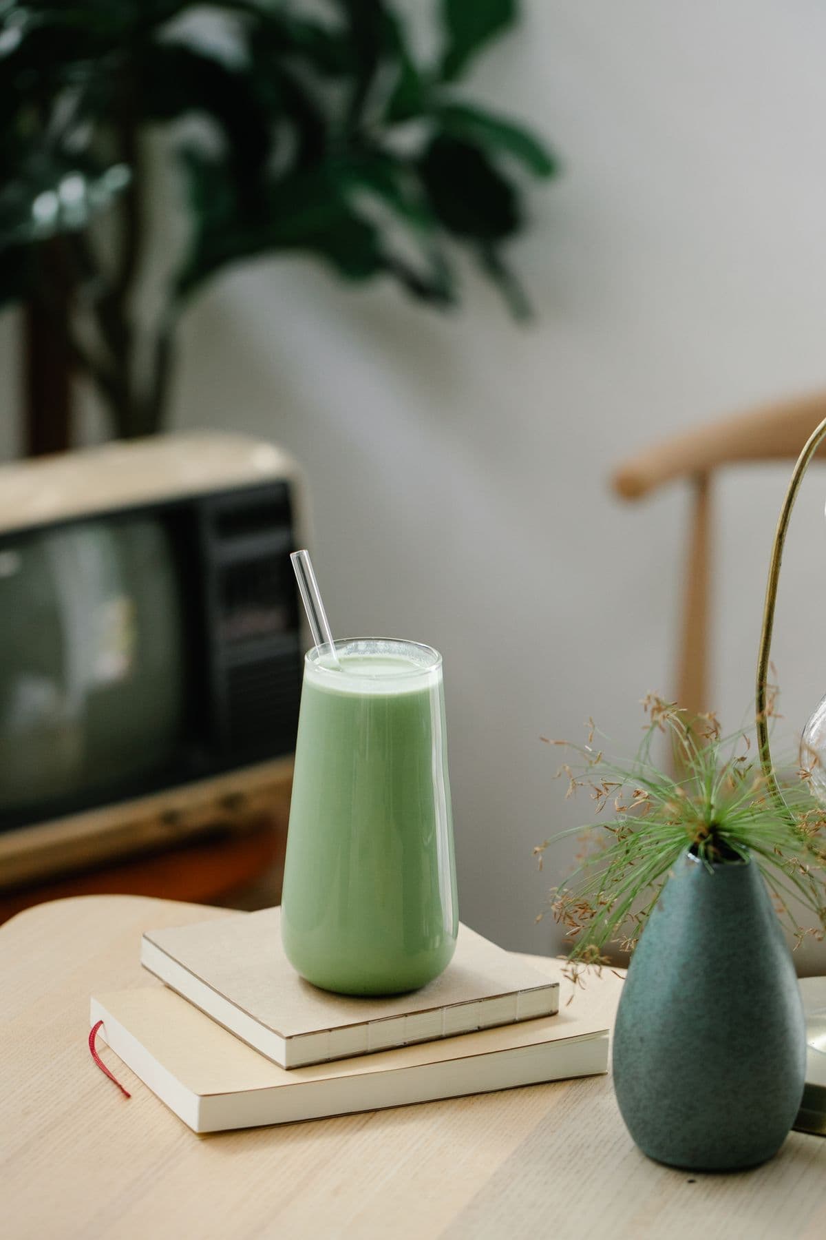 Iced jade-green matcha latte with layered milk in a glass