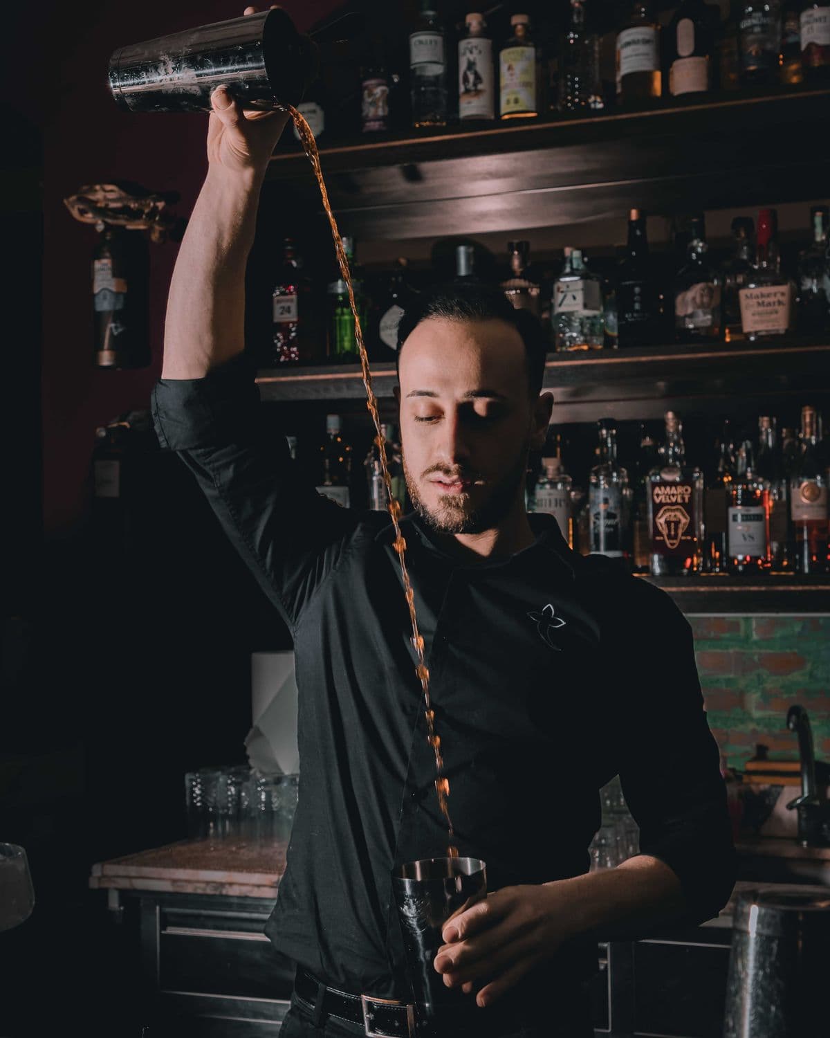 Professional bartender mixing drinks at an event